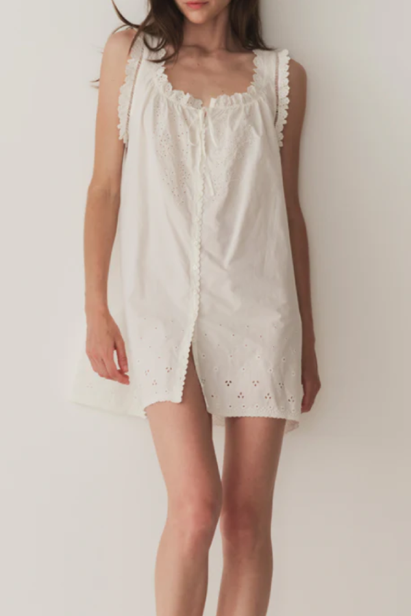 Short Skirt with Pearl Buttons and Scalloped Trim and Round Neck.