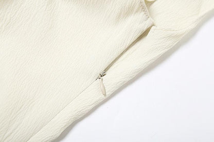 Off shoulder irregular solid zip-up top